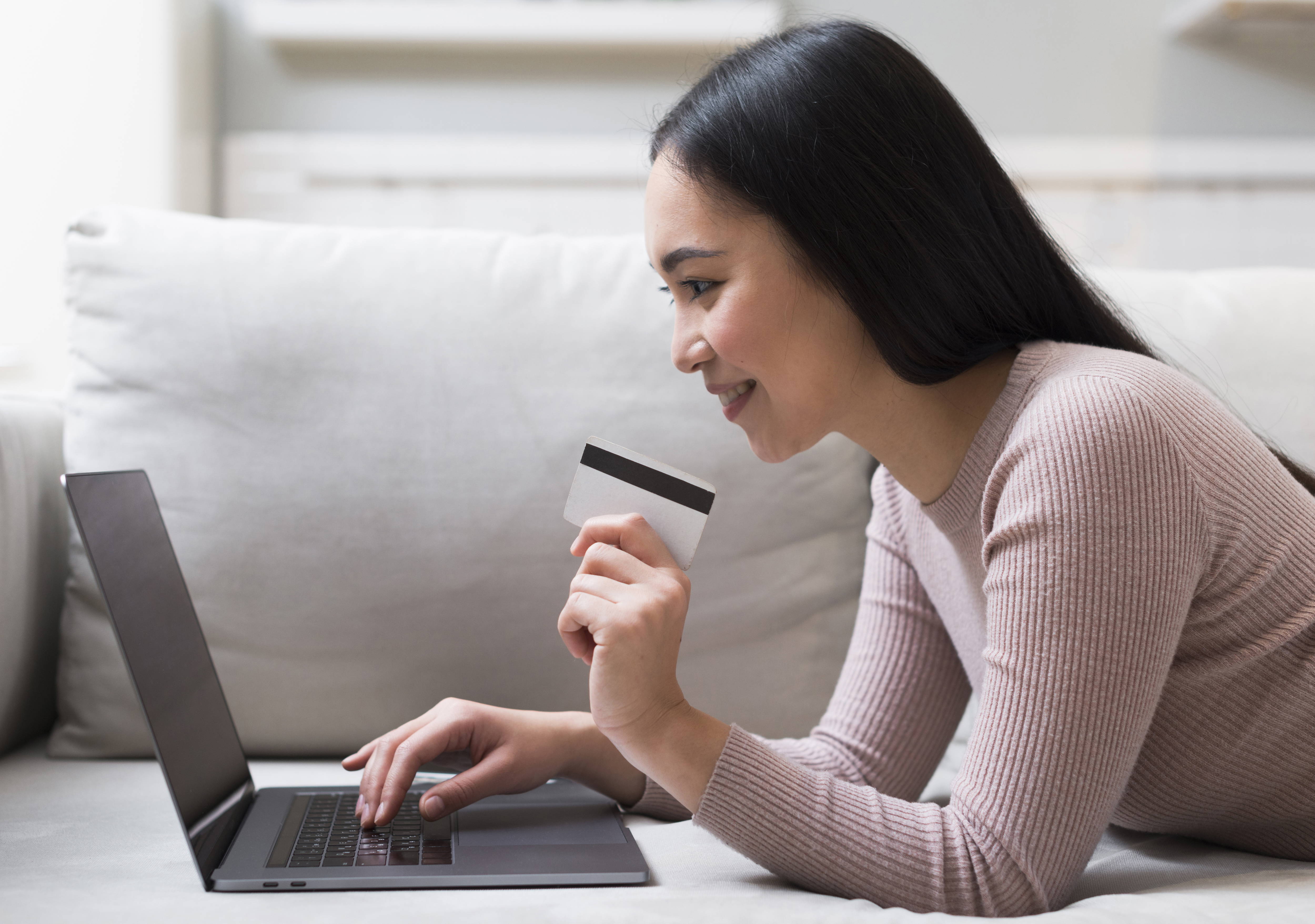 side-view-woman-holding-credit-card-ordering-online copy