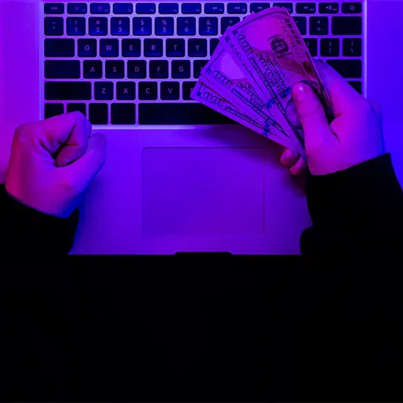 Holding money over laptop