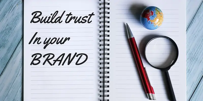 Build trust in your brand written on notepad